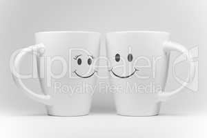 Two white mugs with facial expressions.