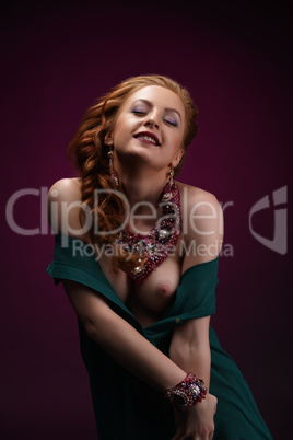 Erotica. Gorgeous redhead model posing in jewelry