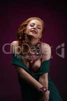 Erotica. Gorgeous redhead model posing in jewelry