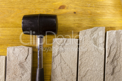 Black rubber mallet and facing stones