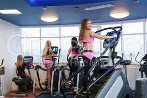 Image of workout in gym. Cute girl poses at camera