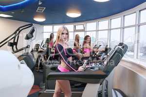 Group of pretty girls training in fitness centre