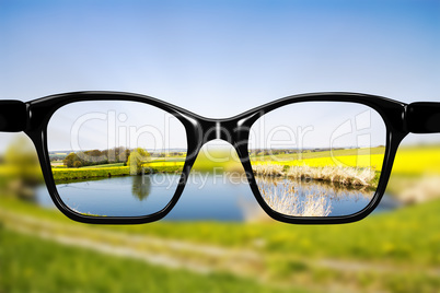 Glasses against natural scenery