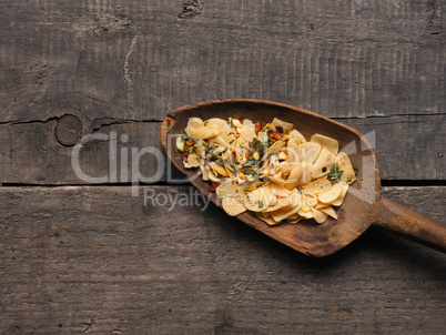 Slices of dried garlic with spicy herbs , view from above