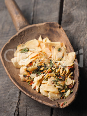 Dried garlic and herbs on an old shovel