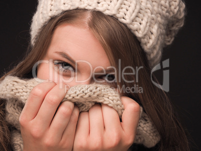 Attractive young woman hiding her face with a scarf