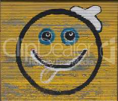 Smiley smiling face symbol smile spray on metal sheet wall graffiti photo