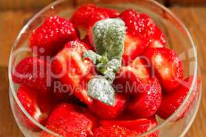 ripe strawberries in a transparent bowl