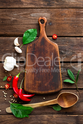 dark culinary background with various herbs and spices, top view, rustic style