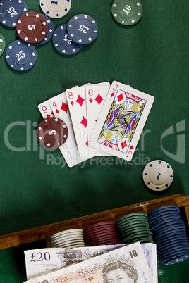 Cards with poker hand with chips and money