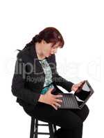 Woman wondering what is on laptop.