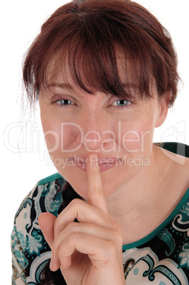 Lovely woman holding finger over mouth.