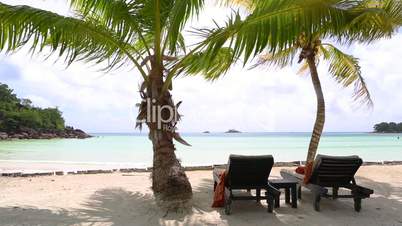 Tropical beach view with deckchairs, Seychelles