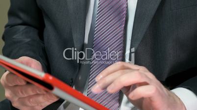 Businessman communicates in a chat using a tablet