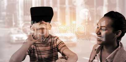 Composite image of little boy holding virtual glasses and giving