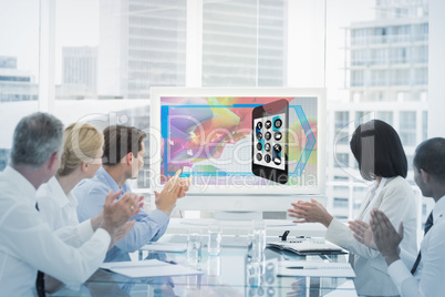 Composite image of business team clapping during a conference