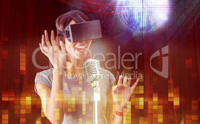 Composite image of businesswoman holding virtual glasses on a wh