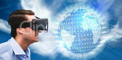 Composite image of profile view of businessman holding virtual g