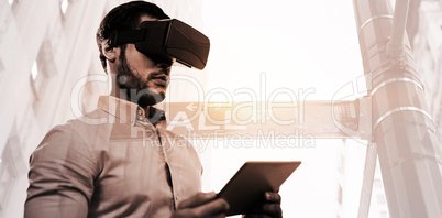 Composite image of low angle view of businessman holding virtual