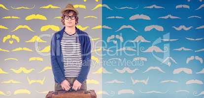 Composite image of serious hipster holding a suitcase