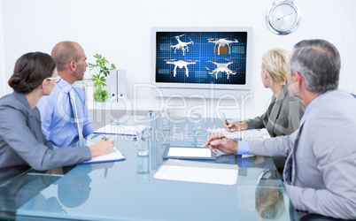 Composite image of business team looking at time clock