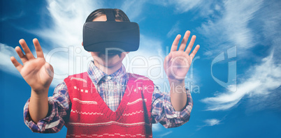 Composite image of young boy in red jumper with virtual reality