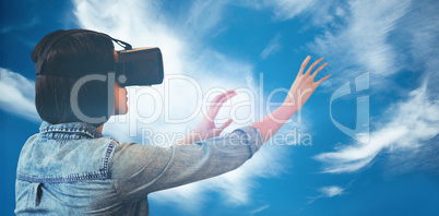 Composite image of side view of businesswoman holding virtual gl