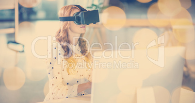 Businesswoman using virtual reality headset in office