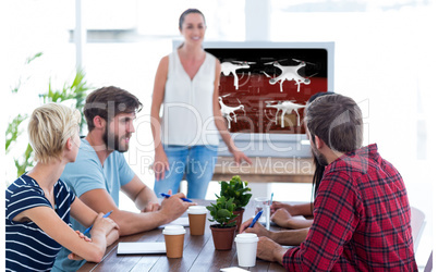 Composite image of casual businesswoman giving presentation to h