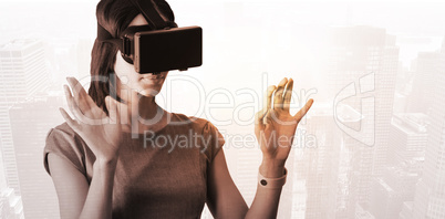 Composite image of businesswoman holding virtual glasses on a wh