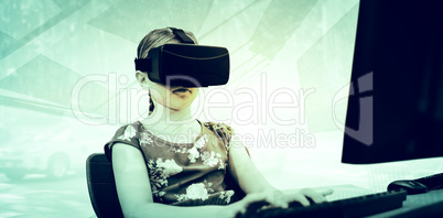 Composite image of little girl holding virtual glasses front of