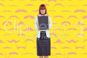 Composite image of smiling hipster woman holding blackboard