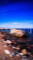 Vertical vivid stony beach motion blurred abstraction background