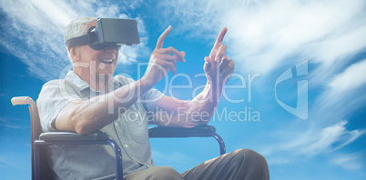 Composite image of senior man holding virtual glasses sitting on