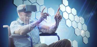 Composite image of senior man holding virtual glasses sitting on