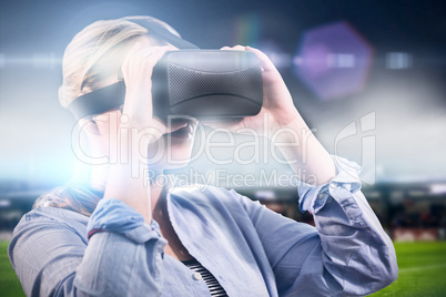 Composite image of woman using an oculus