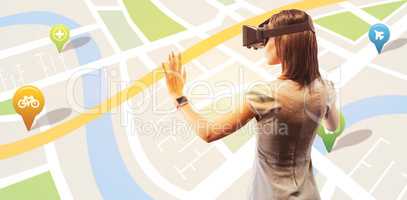 Composite image of rear view of businesswoman holding virtual gl