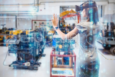 Composite image of rear view of businesswoman holding virtual gl