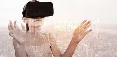 Composite image of little girl holding virtual glasses