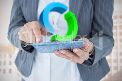 Composite image of  businesswoman using her tablet