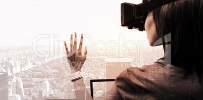 Composite image of woman using a virtual reality device