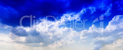 Horizontal vivid blue cloudscape dramatic clouds background back