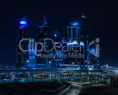 Horizontal vivid blue night Moscow city business center backgrou