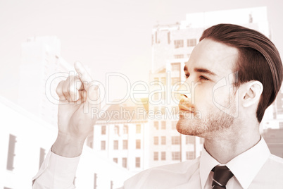 Composite image of concentrated businessman pointing with his fi