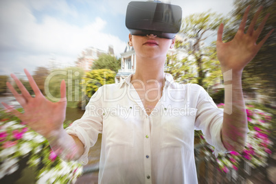 Composite image of woman using a virtual reality device