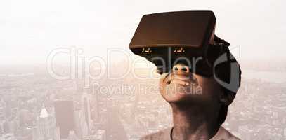 Composite image of little boy holding virtual glasses and lookin