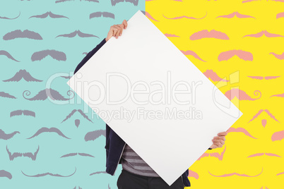 Composite image of man holding billboard in front of face