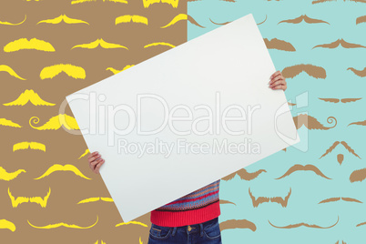 Composite image of hipster woman behind a big white card