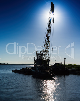 Vertical vivid lifting hoisting crane ship silhouette back light