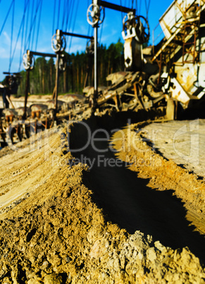 Vertical vivid sand mining machine bokeh background backdrop